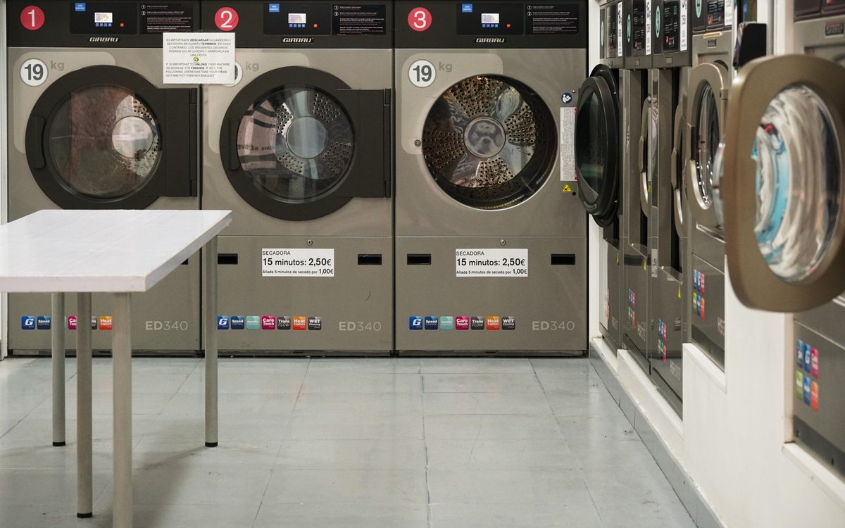 Industrial washing machines in a senior living laundry room